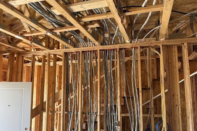Organized electrical rough in wiring run through the framing of a new home